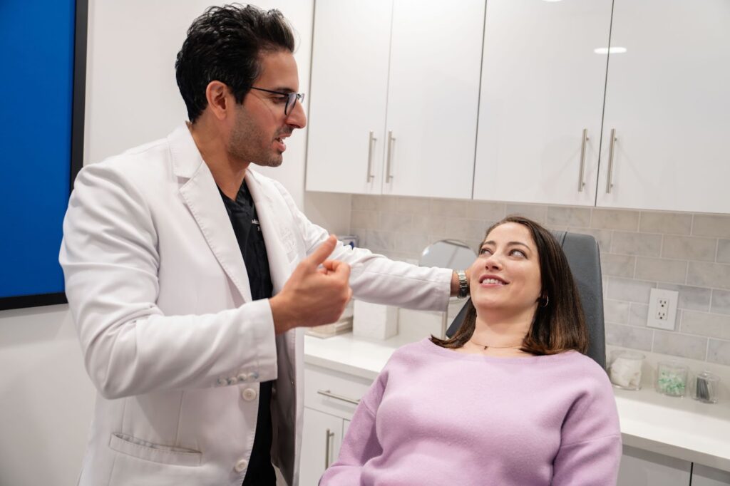 Dr. Bassiri-Tehrani evaluates a patient's midface and cheeks to determine whether she is a candidate for an endoscopic facelift or a traditional facelift